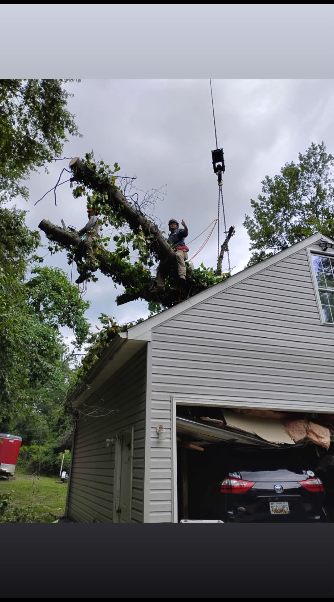 Storm damage remediation by Barton's Tree Care — tree removed from a residential structure